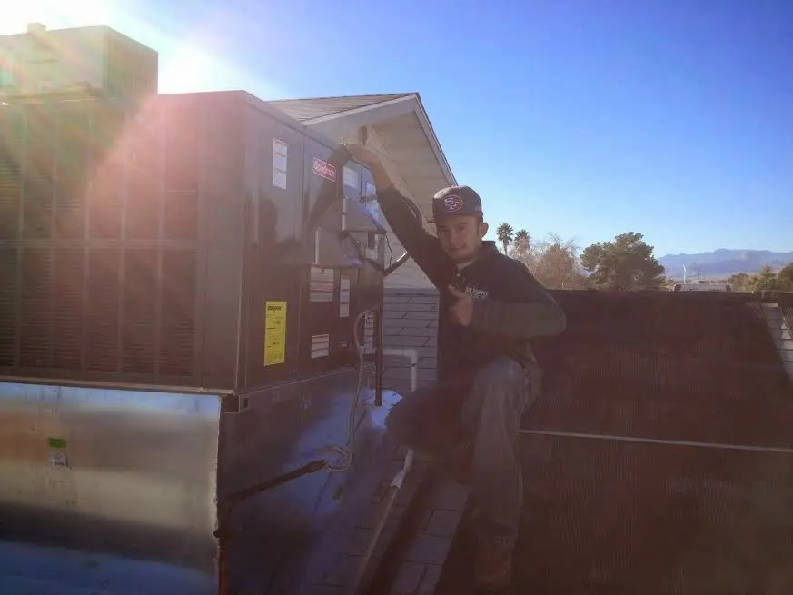 HVAC technician performing Air Duct Cleaning on a rooftop unit in Bridgeton